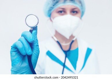 A Cardiologist In A Medical Mask Holds A Stethoscope In His Hand. Heart Exam And Medical Examination.