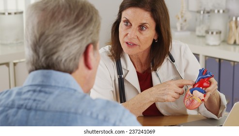 Cardiologist Talking To Elderly Patient About His Heart