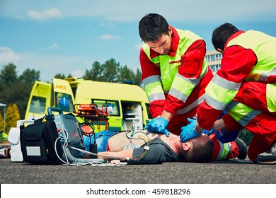 Cardiopulmonary resuscitation. Rescue team (doctor and a paramedic) resuscitating the man on the street.  