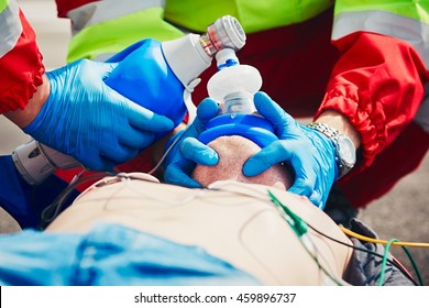 Cardiopulmonary Resuscitation. Rescue Team (doctor And A Paramedic) Resuscitating The Man On The Street. 