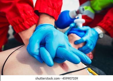 Cardiopulmonary Resuscitation. Rescue Team (doctor And A Paramedic) Resuscitating The Man On The Street. 