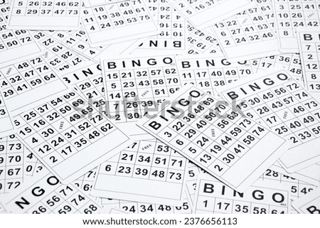 A lot of cards for a board game of bingo or lotto on a light background. Russian Lotto has the same rules as the classic worldwide bingo game.