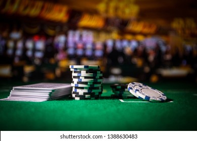 Cards and chips on green felt casino table. Abstract background with copy space. Gambling, poker, casino and cards games theme. Casino elements on green. Selective focus - Powered by Shutterstock