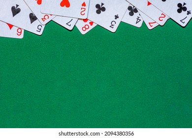Cards On Green Felt Casino Table. Background With Copy Space In Center