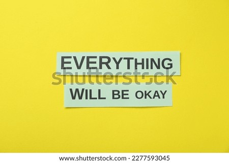 Cards with phrase Everything Will Be Okay on yellow background, flat lay