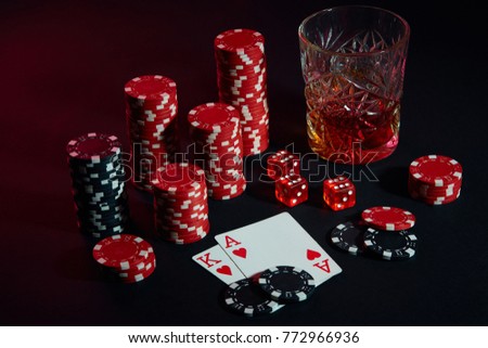 Cards of poker player. On the table are chips and a glass of cocktail with whiskey. Cards - Ace and King