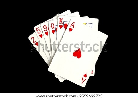 Cards of the same suit lie on a black background.