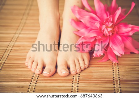 Care for beautiful woman legs with flower . Beautiful woman legs