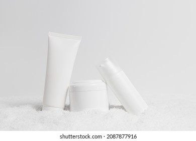 Care Cosmetics Blank Bottles In Snow, White Mockup Containers, Winter Skin Care