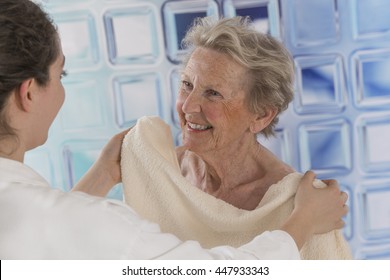 Care Giver Or Nurse Assisting Elderly Woman For Shower