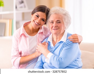 Care Of Senior Woman At Home Sitting On The Couch