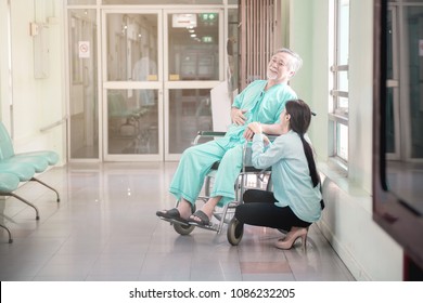 Care Taker With Patient. Taken Care Of Old Chinese Man In Wheel Chair. Female Nurse And Care Taker With Senior Chinese Man.