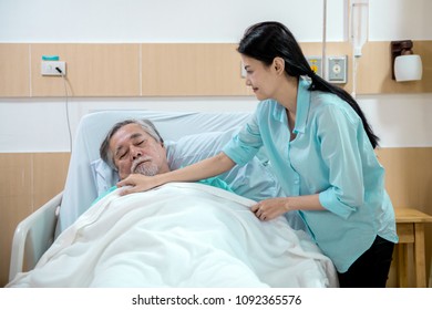 Care Taker With Patient. Taken Care Of Old Chinese Man In Wheel Chair. Female Nurse And Care Taker With Senior Chinese Man.