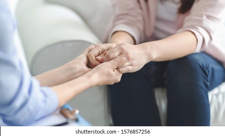 Care, trust, professionalism concept. Close up of therapist holding female patient hands, comforting her client, panorama with copy space