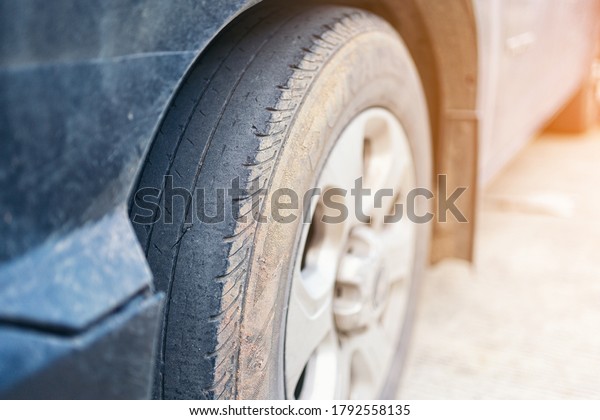 Care use unsafe tire, change time for a\
front wheel rubber worn, bald, black, old and low tread car tires.\
Driving on worn tires is a safety\
hazard