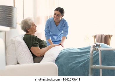 Care Worker With Elderly Woman In Geriatric Hospice