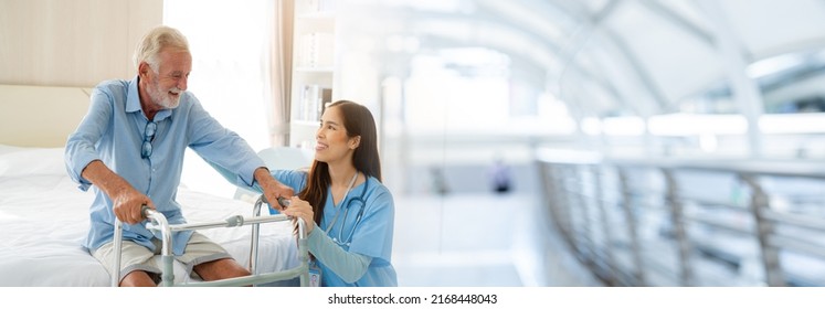 Care worker helping elderly man get out of bed and walk around the room, Image panorama for cover design.	 - Powered by Shutterstock