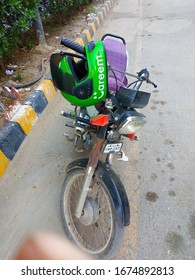 A Careem Bike With Green Colored Helmet On It , In The City Of Karachi. Ride Hailing Services Have Become Backbone In The Absence Of Good Public Transportation System - Sindh Pakistan - Mar 2020