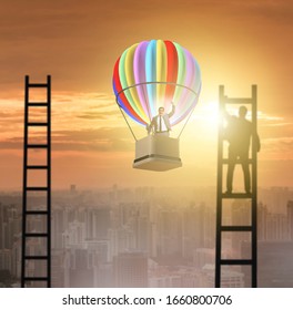 Career achievement concept with businessman on balloon and ladde
