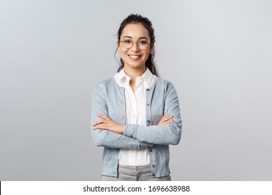 Career, business and education concept. Portrait of cheerful asian girl ready to start online lesson with students, explain class new theme, cross hands chest confident, smiling self-assured - Shutterstock ID 1696638988