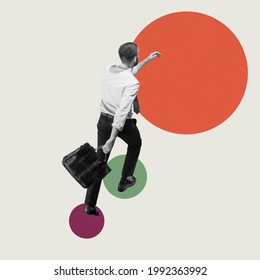 Career ladder. Up to success. Young man, businessman, finance analyst or clerk in business clothes going up on abstract art background. Concept of finance, target, professional occupation, business - Shutterstock ID 1992363992