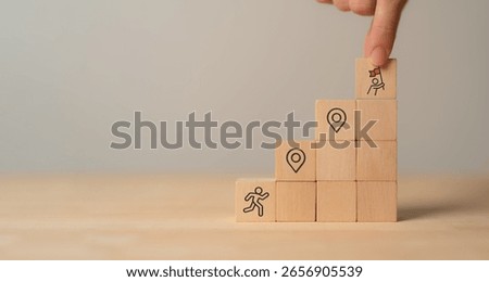 Career Path and Development Strategy Concept. Arranging wooden blocks with icons success roadmap and journey, symbolizing a structured career path and strategic development. Planning, growth, progress