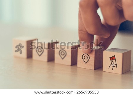 Career Path and Development Strategy Concept. Arranging wooden blocks with icons success roadmap and journey, symbolizing a structured career path and strategic development. Planning, growth, progress