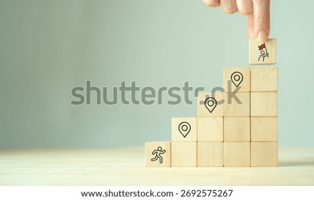 Career Path and Development Strategy Concept. Arranging wooden blocks with icons success roadmap and journey, symbolizing a structured career path and strategic development. Planning, growth, progress