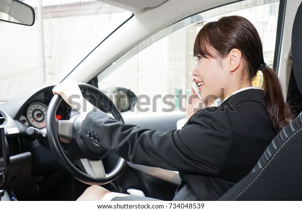 Career woman telephoning in
car