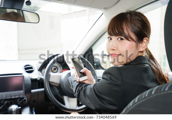 Career woman telephoning in\
car