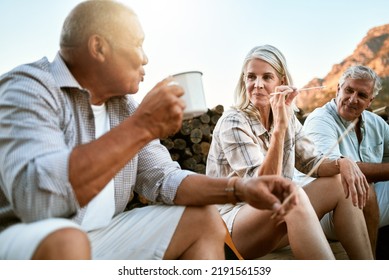 Carefree, Adventure And Exploring Friends Talking, Bonding And Enjoying Relaxing Outdoors. Senior Group Enjoying A Break After Hiking In The Forest, Mountains Or Woods Together Having Drinks Or