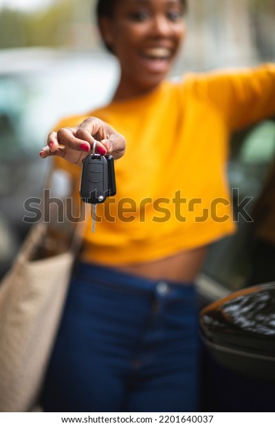 Carefree\
african american woman showing new car\
key