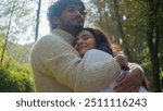 Carefree Arabian Indian affectionate couple smiling woman man male boyfriend hugging female girlfriend wife husband enjoy closeness in park romantic date lady guy touching embracing cuddle honeymoon