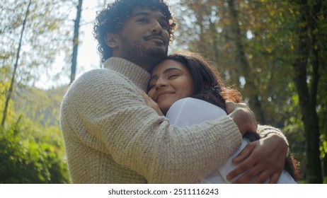 Carefree Arabian Indian affectionate couple smiling woman man male boyfriend hugging female girlfriend wife husband enjoy closeness in park romantic date lady guy touching embracing cuddle honeymoon - Powered by Shutterstock