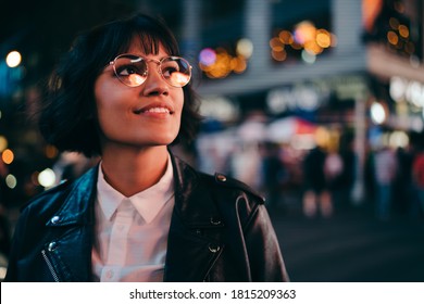 Carefree Brunette Young Woman With Short Haircut In Stylish Eyewear For Eyes Protection Fascinated With New York Urbanity In Manhattan,youthful Female In Leather Jacket Enjoying Metropolitan Nightlife