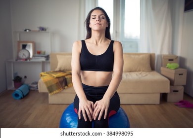 Carefree Calm Woman Meditating.Enjoying Peace And Serenity.Living Room For After Work Relaxation And Meditation.Having A Deep Breath.After Work Out Relaxation Of Muscles And Breathing Exercises