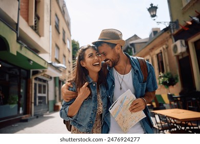 Carefree couple walking in the city during their summer travel. - Powered by Shutterstock