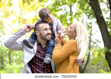 Carefree Family Having Fun While Running In The Park