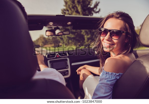Carefree gorgeous cheerful lady wife turn for\
shot, back view of driver husband, on their way to honeymoon.\
Feelings, married family, friendship, reach destination, escape,\
speed ride, relax\
lifestyle
