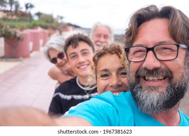 Carefree Group Of Multi Generation Family Taking A Selfie Outdoor At The Beach, Looking At Camera Smiling