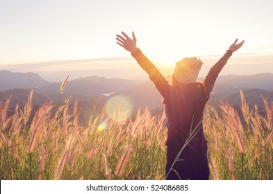 Carefree Happy Woman Enjoying Nature on grass meadow on top of mountain cliff with sunrise. Beauty Girl Outdoor. Freedom concept. Len flare effect. Sunbeams. Enjoyment. - Shutterstock ID 524086885