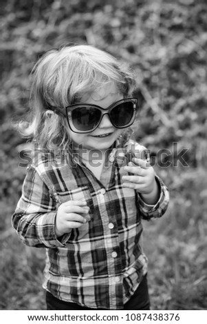 Similar – Adorable little girl playing with a ball sitting on a park bench