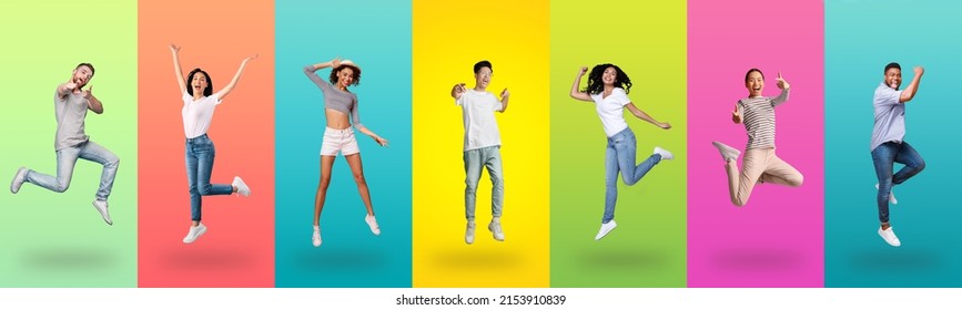 Carefree millennial diverse people jumping up, celebrating victory and pointing finger at you camera, posing together on colorful gradient studio background wall, full length shot, panorama banner