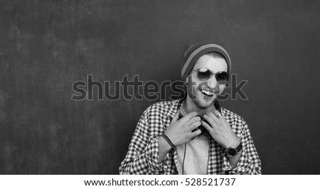 Man with sun hat and sunglasses on an old bridge