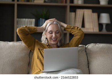 Carefree relaxed older woman put hands behind head looks at laptop, enjoy new series of favourite movie resting seated on cozy sofa. Leisure and fun at home using modern tech, watch on-line TV concept - Shutterstock ID 2166522853