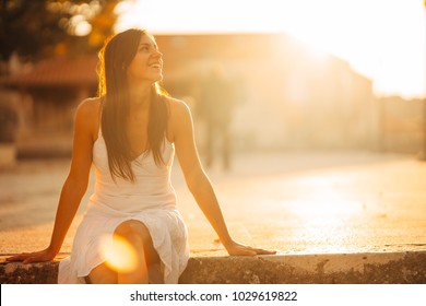 Carefree woman enjoying in nature,beautiful red sunset sunshine.Finding inner peace.Spiritual healing lifestyle.Enjoying peace,anti-stress therapy,mindfulness meditation.Positive energy.Freedom