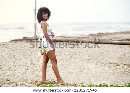 Carefree woman walking on the beach. 