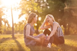 Carefree Women Laughing Joyfully Outdoors In The Park