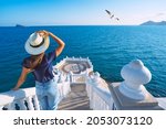 Carefree young tourist woman in sun hat enjoying sea view at Balcon del Mediterraneo in Benidorm, Spain. Summer vacation in Spain