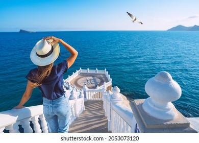 Carefree young tourist woman in sun hat enjoying sea view at Balcon del Mediterraneo in Benidorm, Spain. Summer vacation in Spain - Shutterstock ID 2053073120